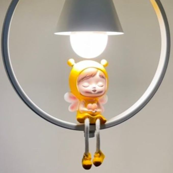 White pendant lamp with a cartoon character figurine hanging from a white ring.