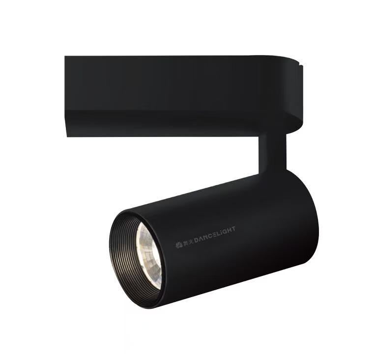 Black cylindrical track lighting fixture, angled downward, attached to a track.