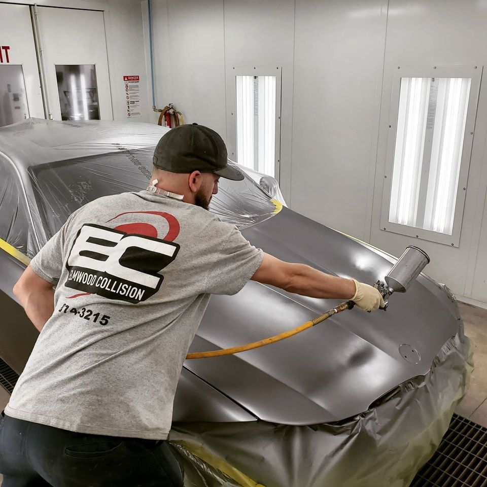 Painting the hood in the down-draft paint booth at Elmwood Collision