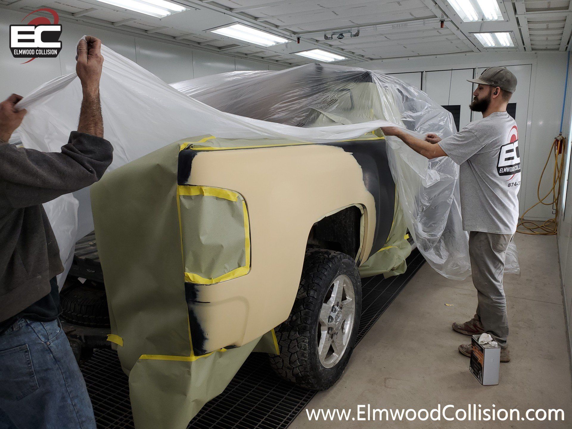 Wrapping a truck before painting quarter panel at Elwmood Collision Buffalo New York