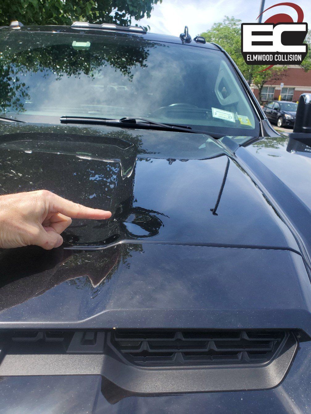 dent in truck hood at elmwood collision
