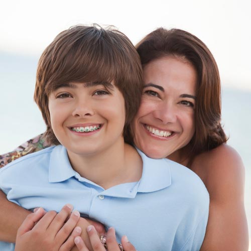 Mother and her son snuggled together on their beach vacation