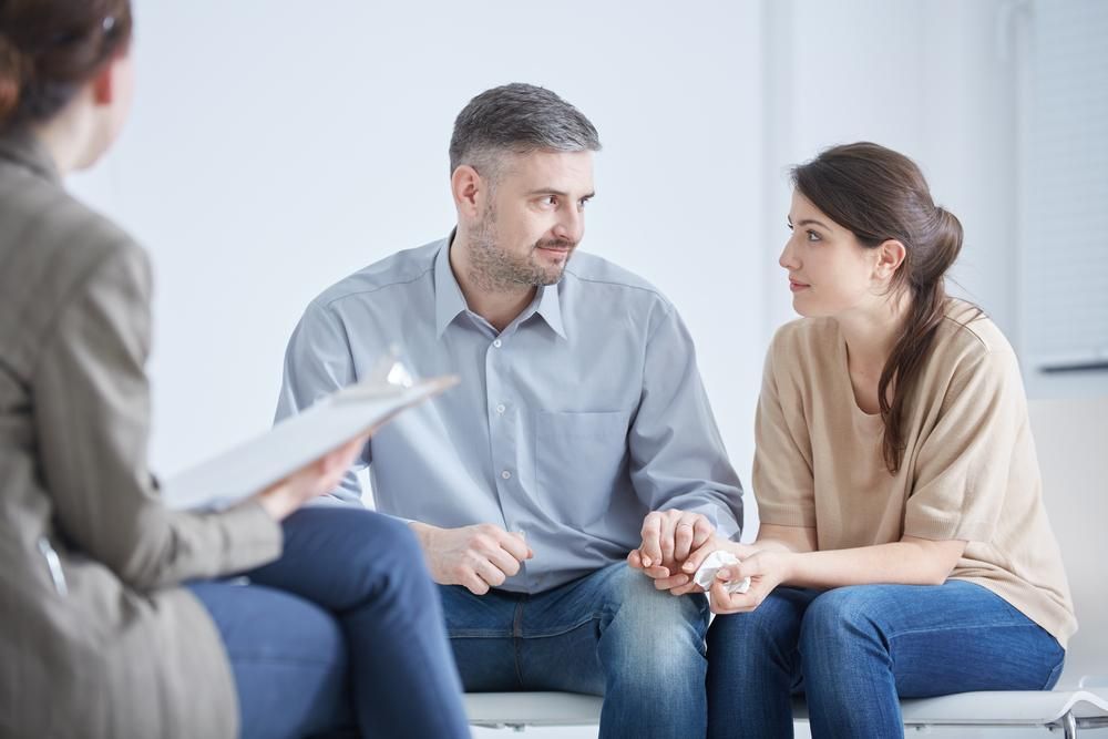 Couple Holding Hands in Therapy Session With a Counselor — EastCoast Women's Centre In Caboolture, QLD