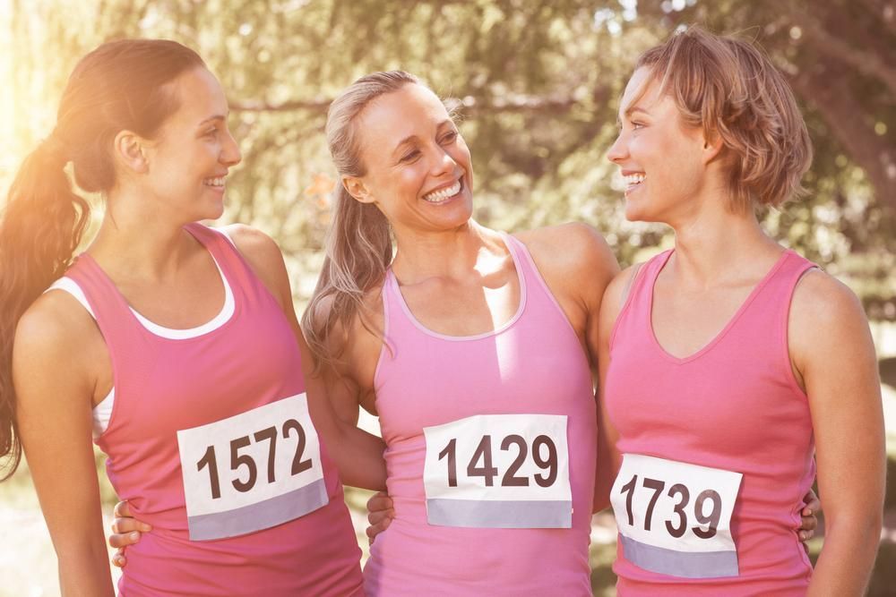 Three Smiling Women in Pink Running Shirts — EastCoast Women's Centre In Maryborough, QLD