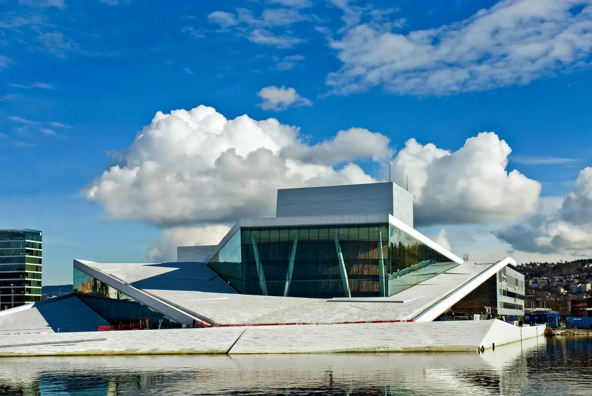 A large building with a blue sky and clouds behind it used in explaining Home Share locations