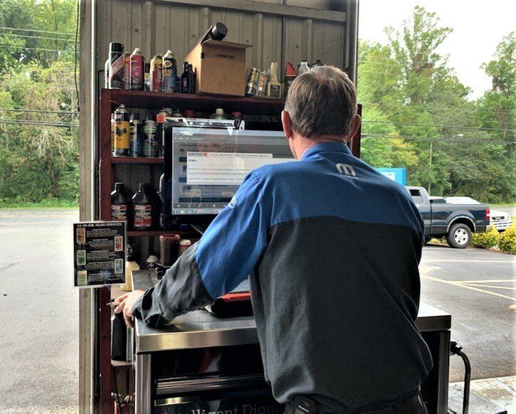 Auto mechanic using a computer