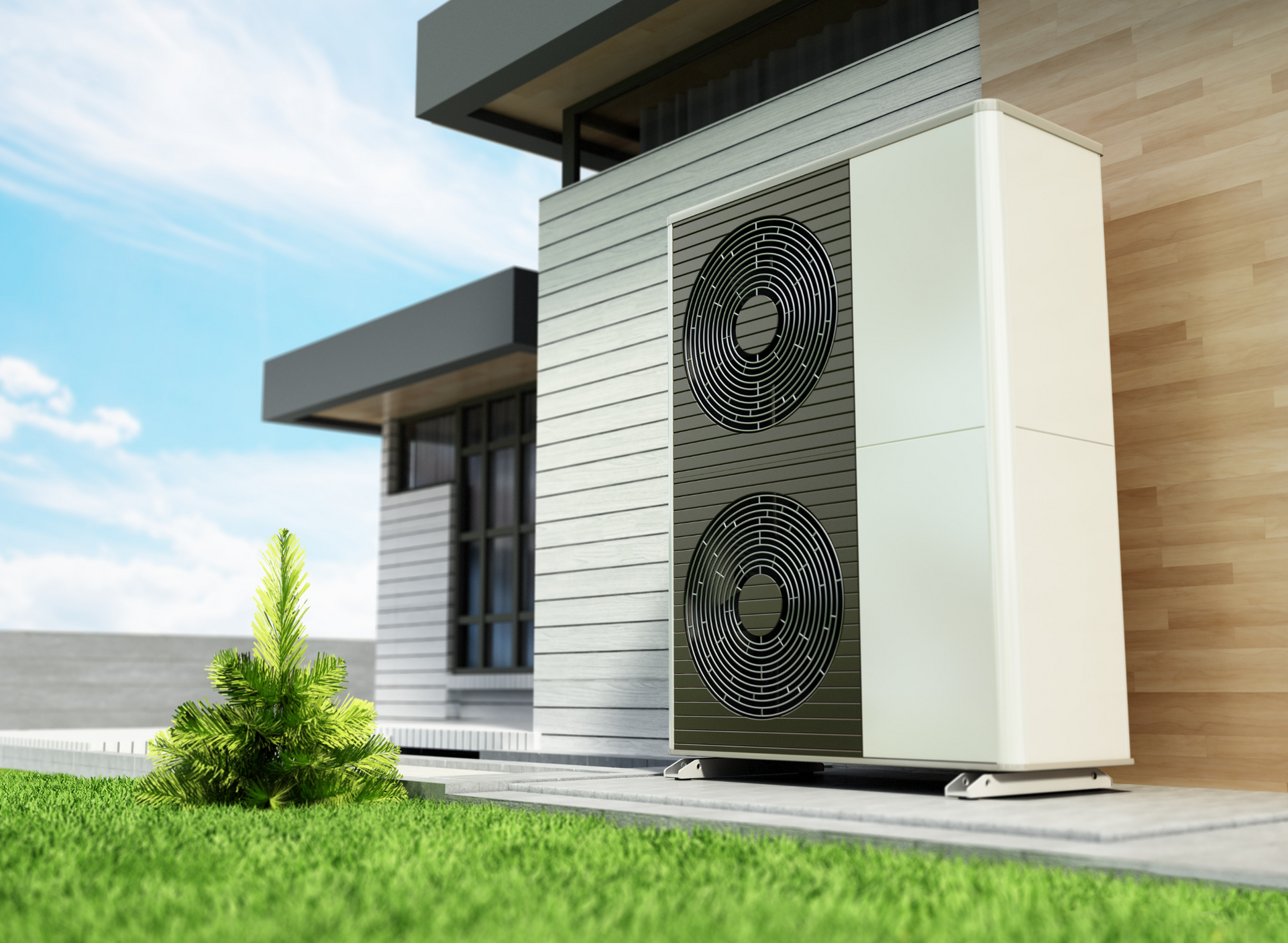 Exterior view of a modern house with a heat pump unit beside it, on a grassy lawn under a blue sky.