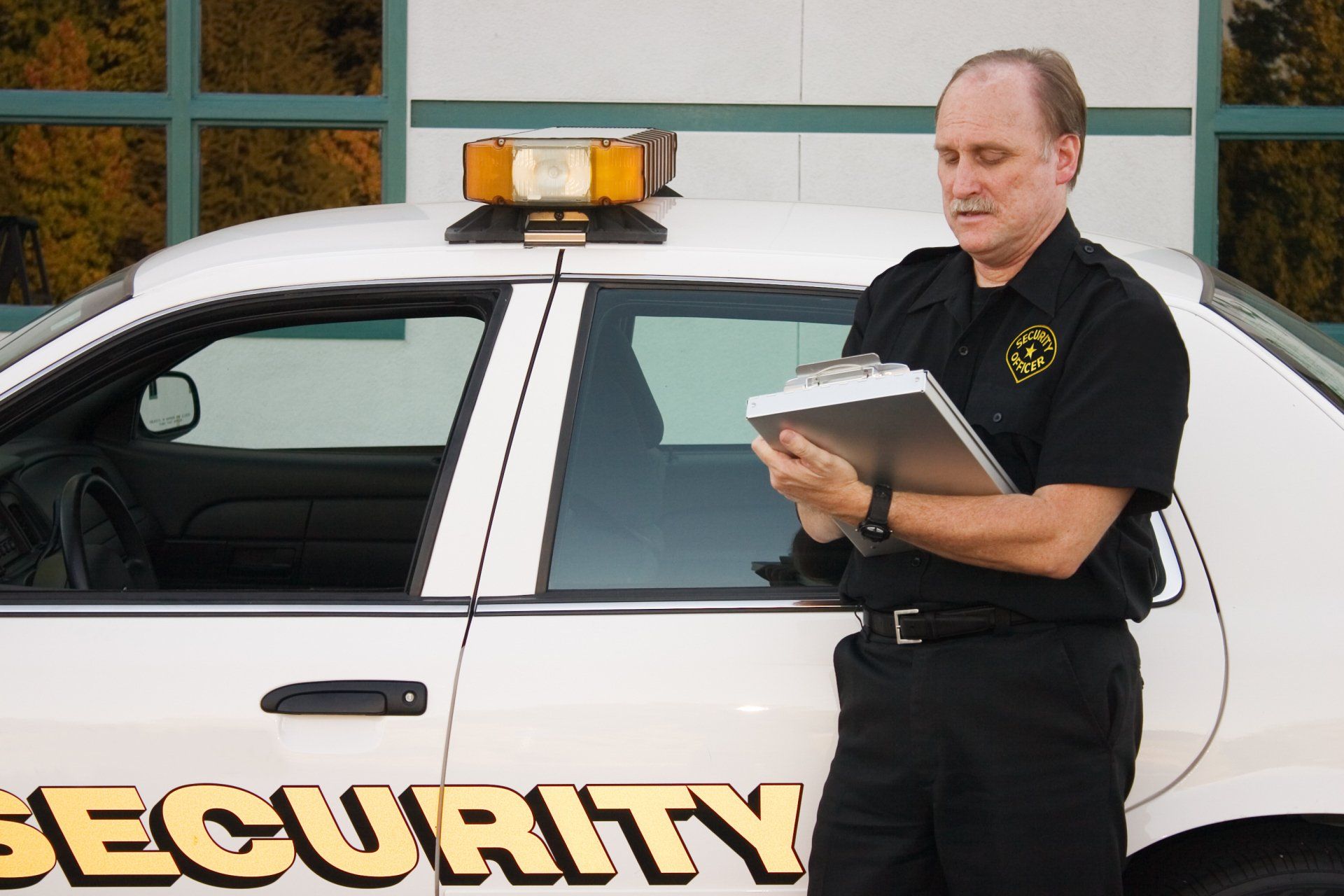 A Security Officer Writing Down His Report — Kent, WA — United Security Patrol