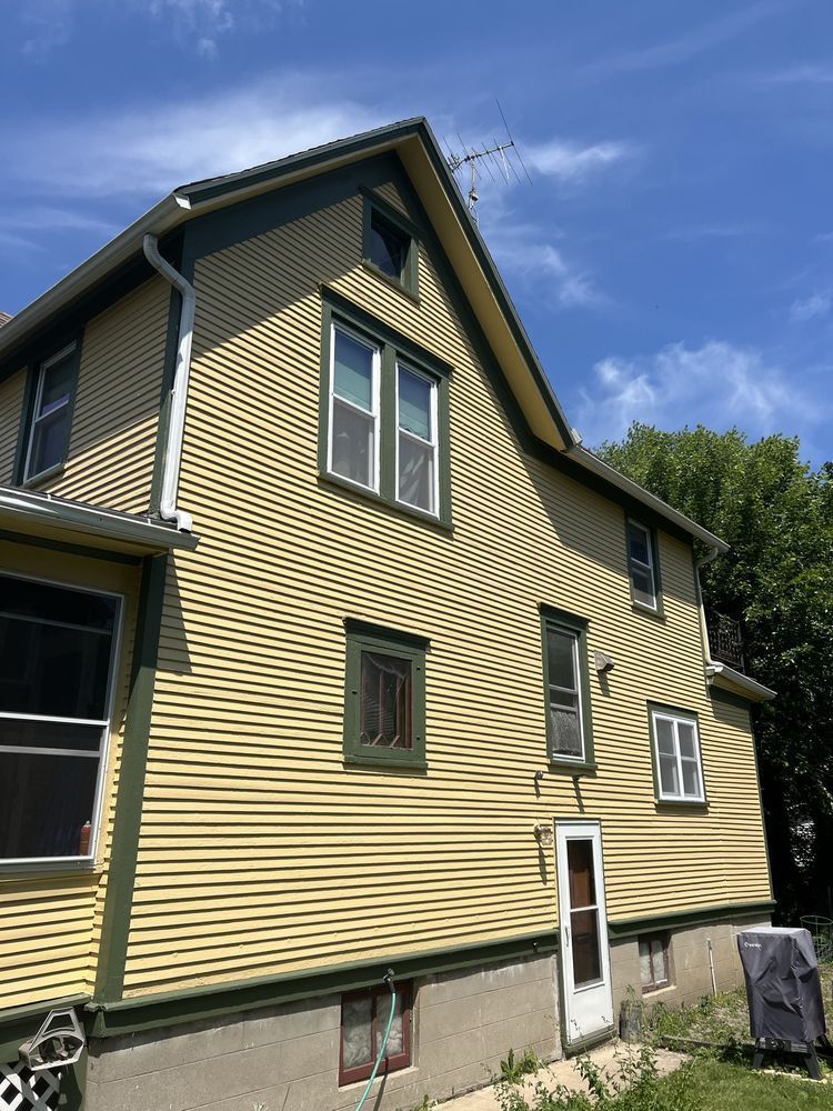 A large yellow house with fresh paint and windows.