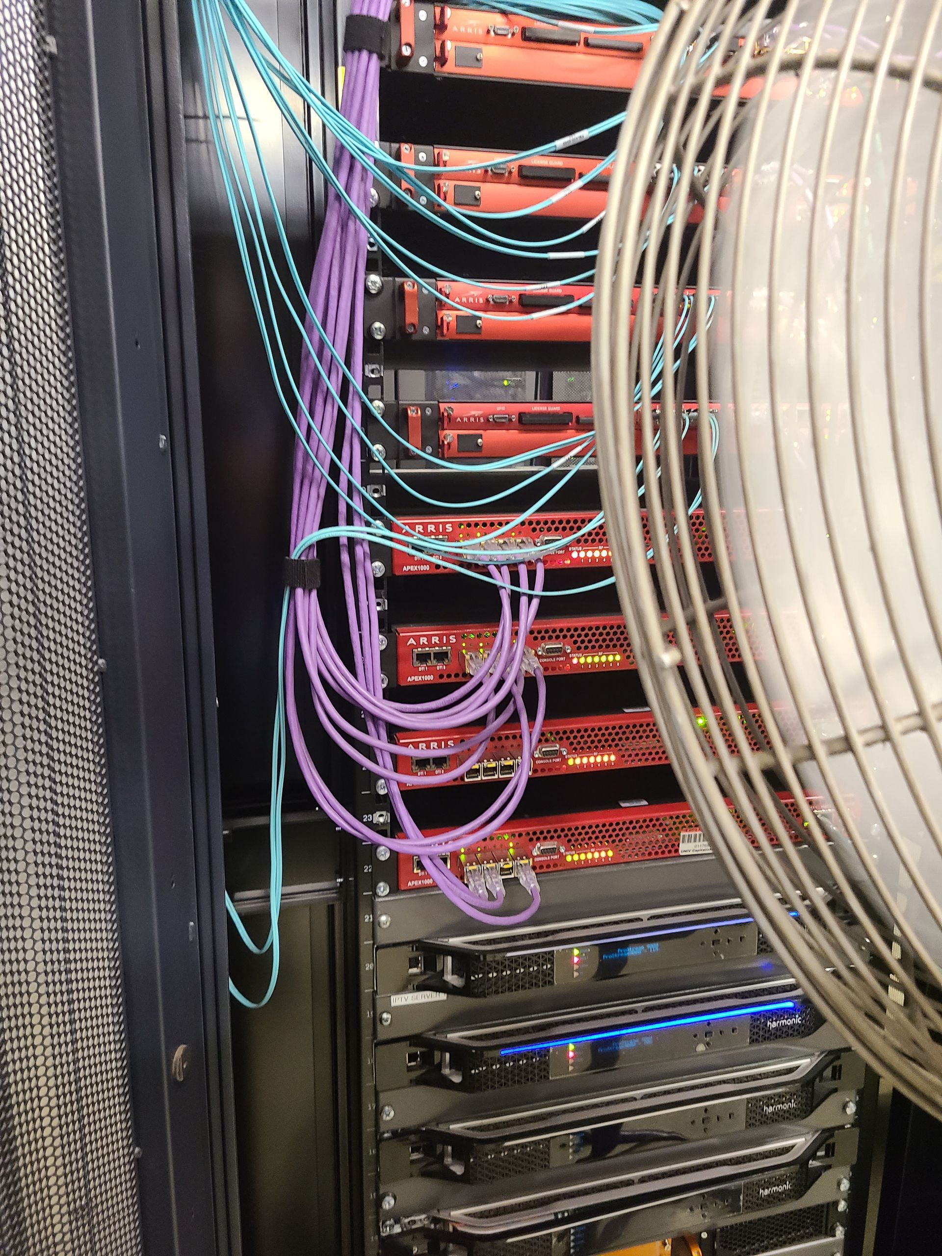 Rope access technician on a building rooftop, wearing safety gear and looking over city. Rope access technician on a building rooftop, wearing safety gear and looking over city.