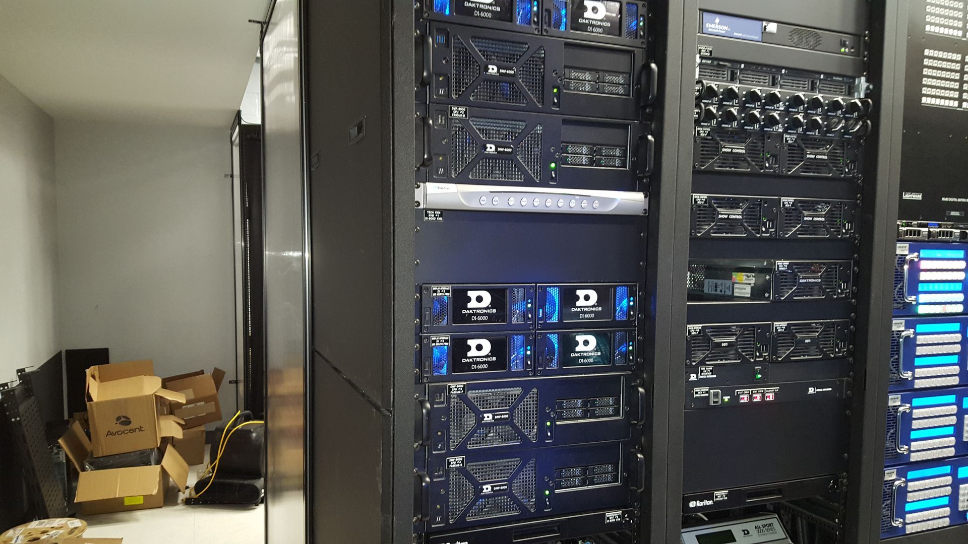 Satellite dish on a rooftop, with buildings and trees in the background.