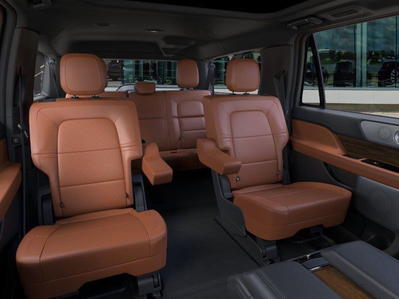 Interior view of a black SUV cargo area with second-row seats folded flat, a cargo liner, and ambient lighting.
