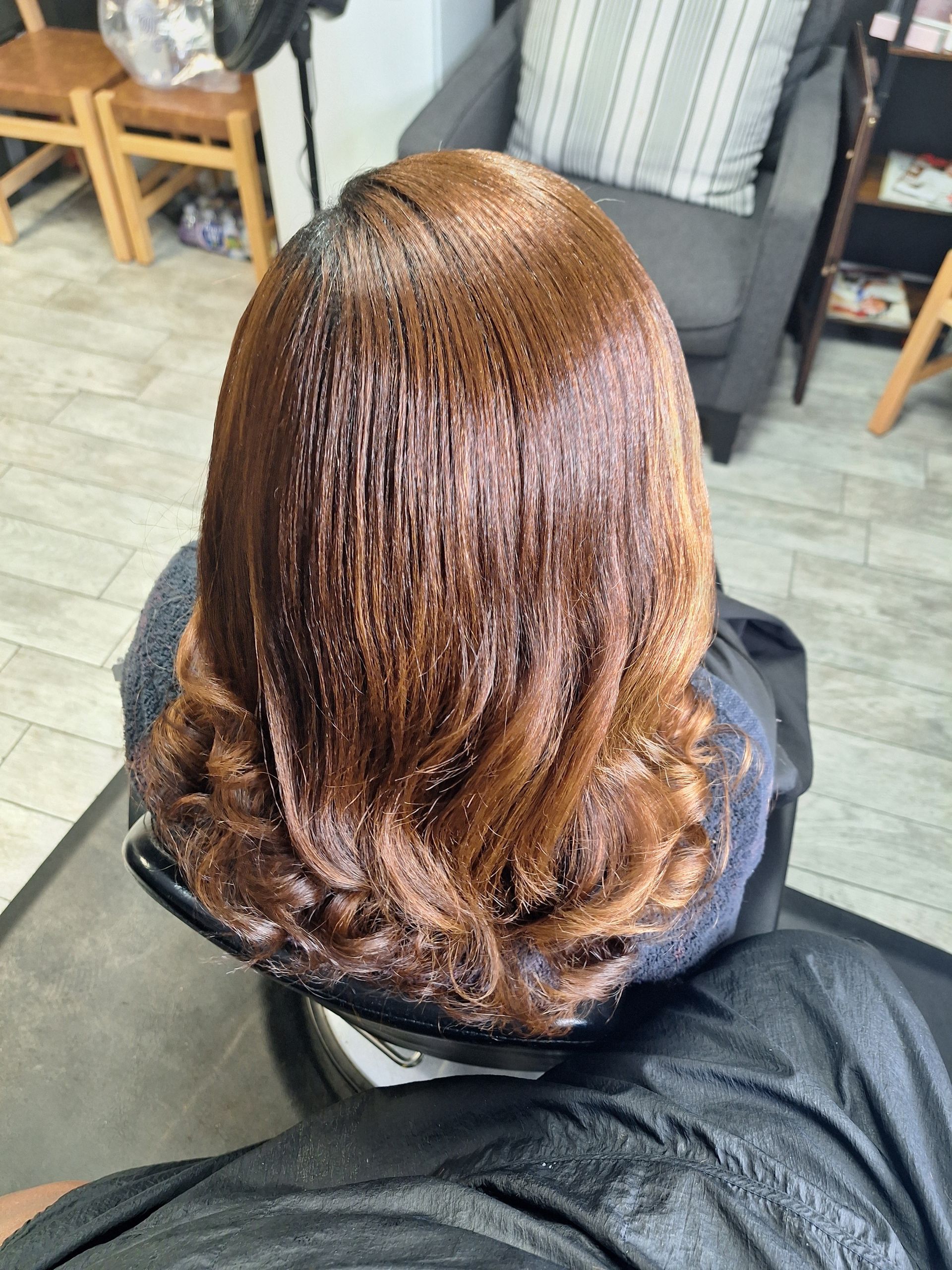 A woman is getting her hair dyed in a salon.