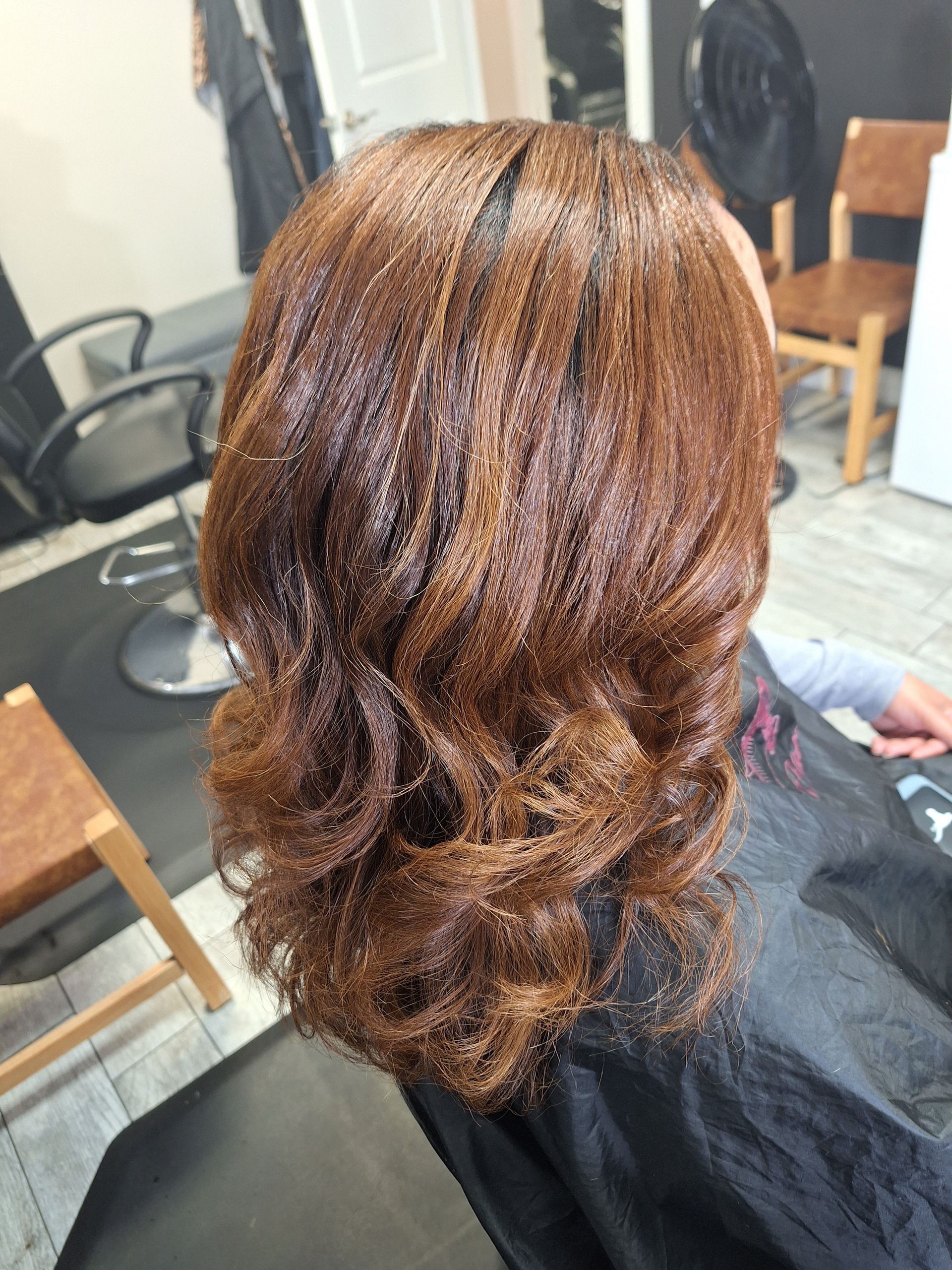 A woman is getting her hair done at a salon.