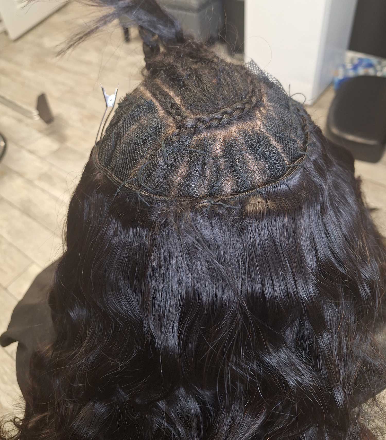 A close up of a person 's head with a wig on.