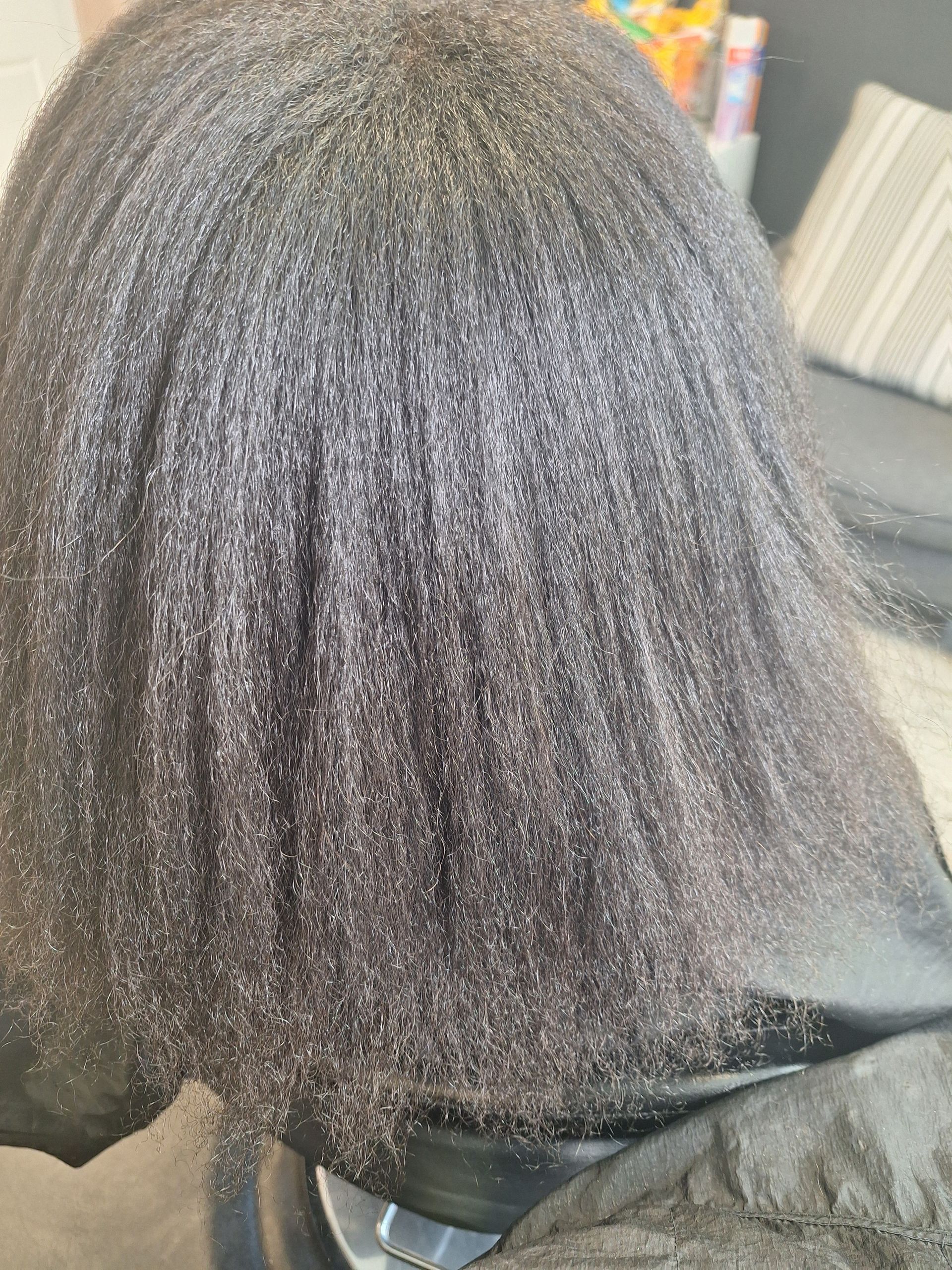 A close up of a person 's hair in a chair.