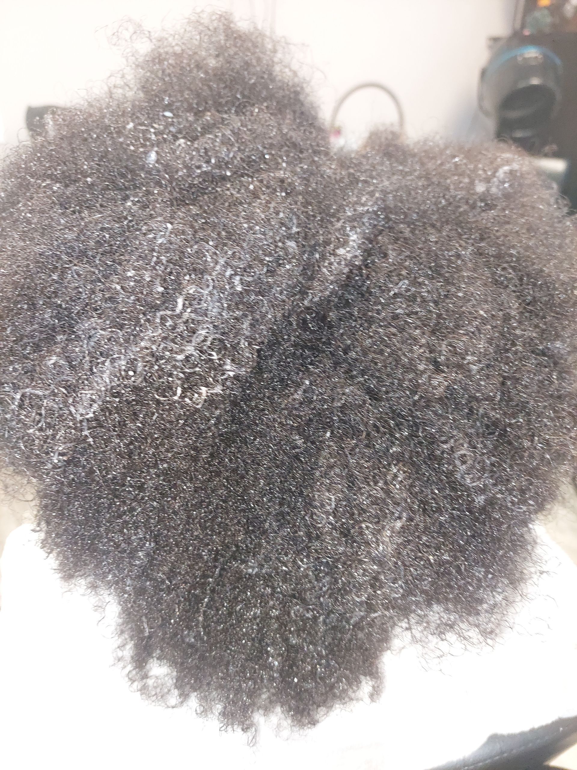 A close up of a person 's hair on a white surface.