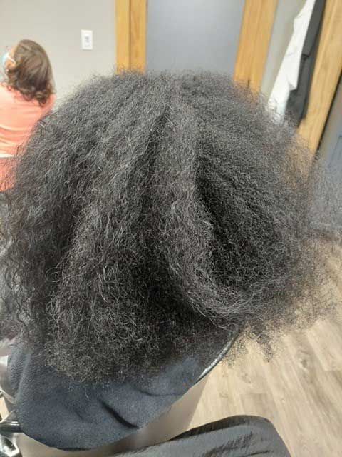 A close up of a person 's hair in a room.