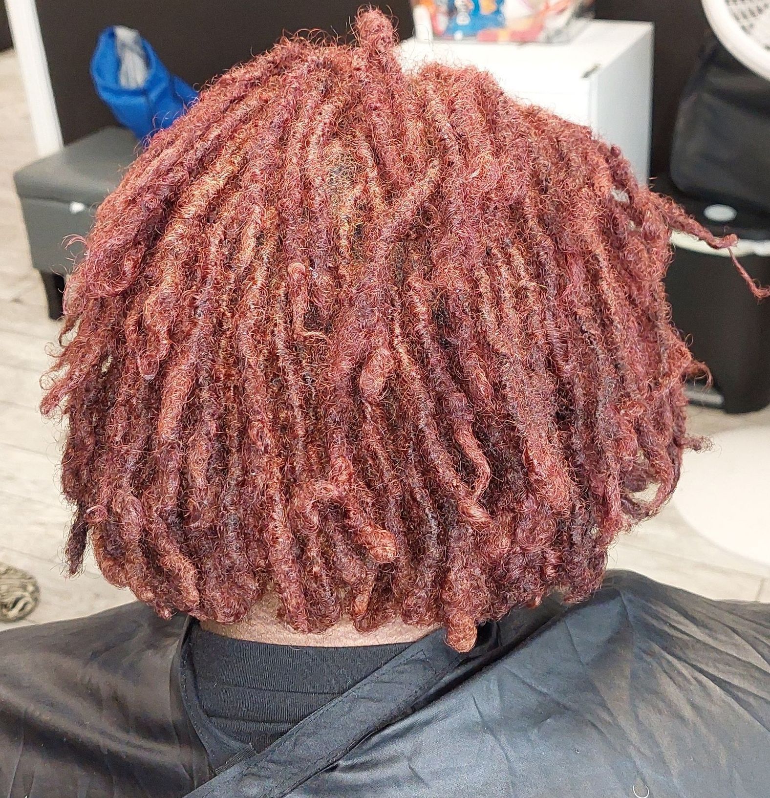 A person is getting their hair cut in a salon.