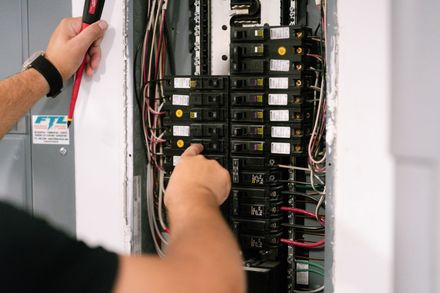 A close up of a electrical box with a lot of wires coming out of it.