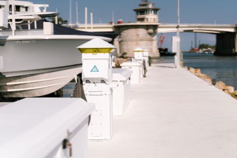 Boats are docked at a marina with a sign that says a on it