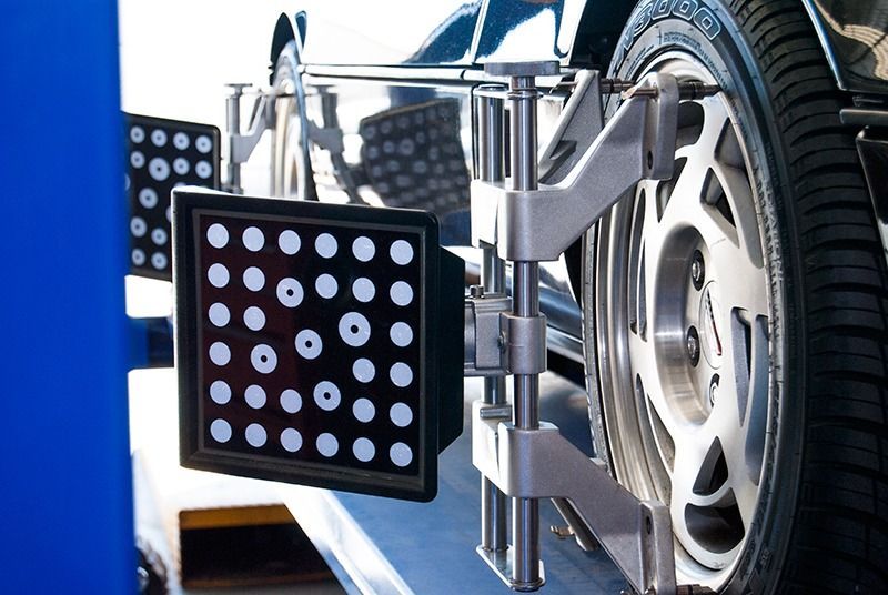 A Car Wheel is Being Aligned With a Machine — Border Power Steering Service In Lavington, NSW
