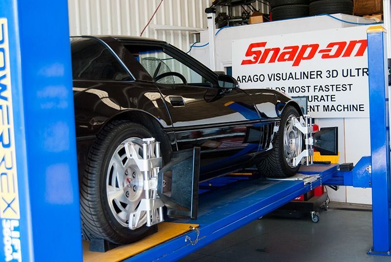 A Car is Sitting on a Lift in Front of a Snap-on Sign — Border Power Steering Service In Lavington, NSW