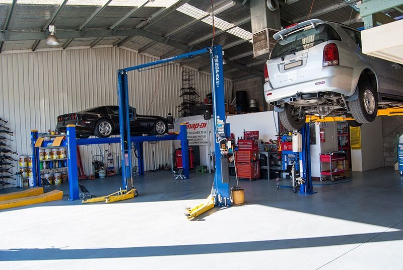 A Car is Sitting on a Lift in a Garage — Border Power Steering Service In Lavington, NSW