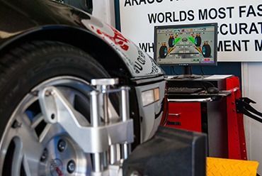 A Car is Being Aligned by a Machine in a Garage — Border Power Steering Service In Lavington, NSW