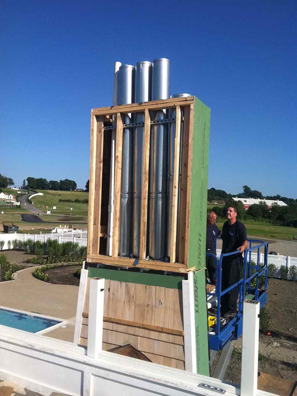 Affordable Plumbing Solutions — Men Looking at the Big Pipe in Middletown, RI