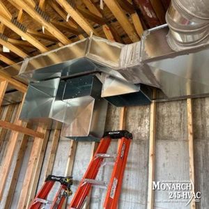 HVAC ductwork installation in a wooden framed ceiling; red ladder below.