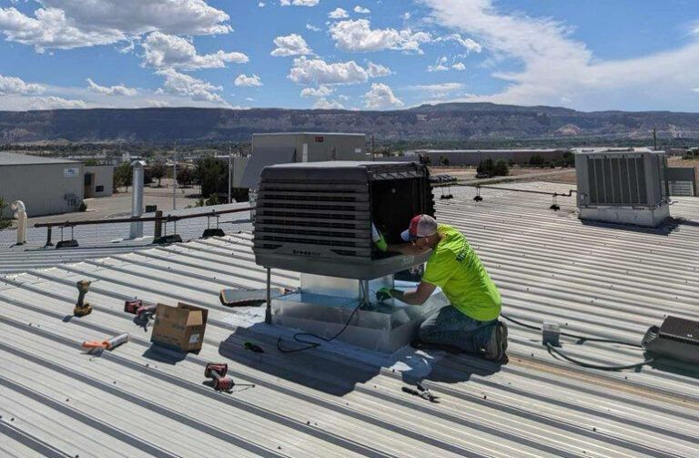 Woman in straw hat smiles, holding wine glass near a lake.