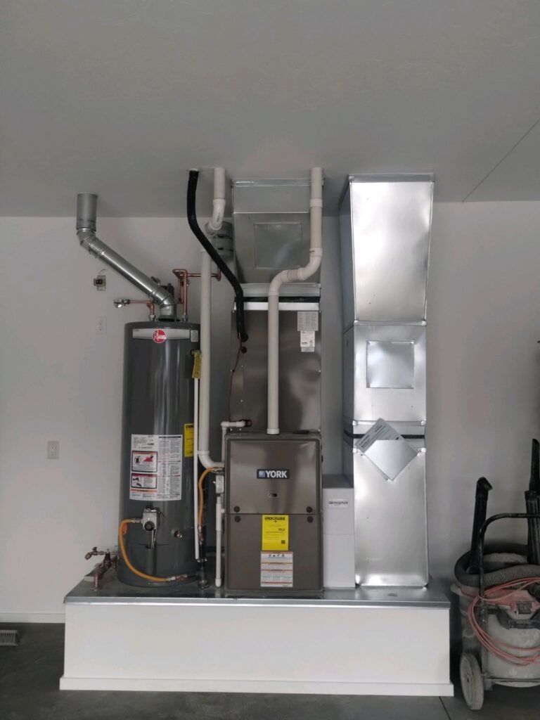 Woman in straw hat smiles, holding wine glass near a lake.