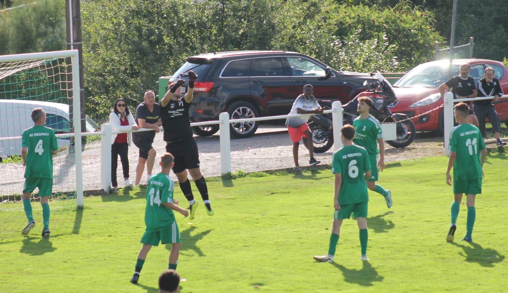 Un groupe de joueurs de football jouent à un jeu sur un terrain.