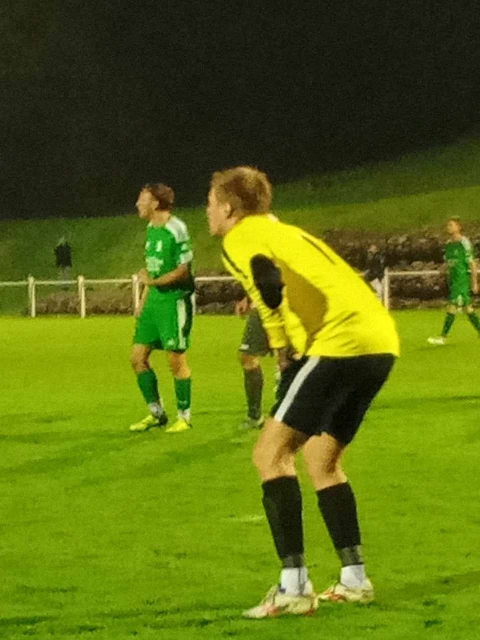 Un joueur de football portant un maillot jaune avec le numéro 1 dessus