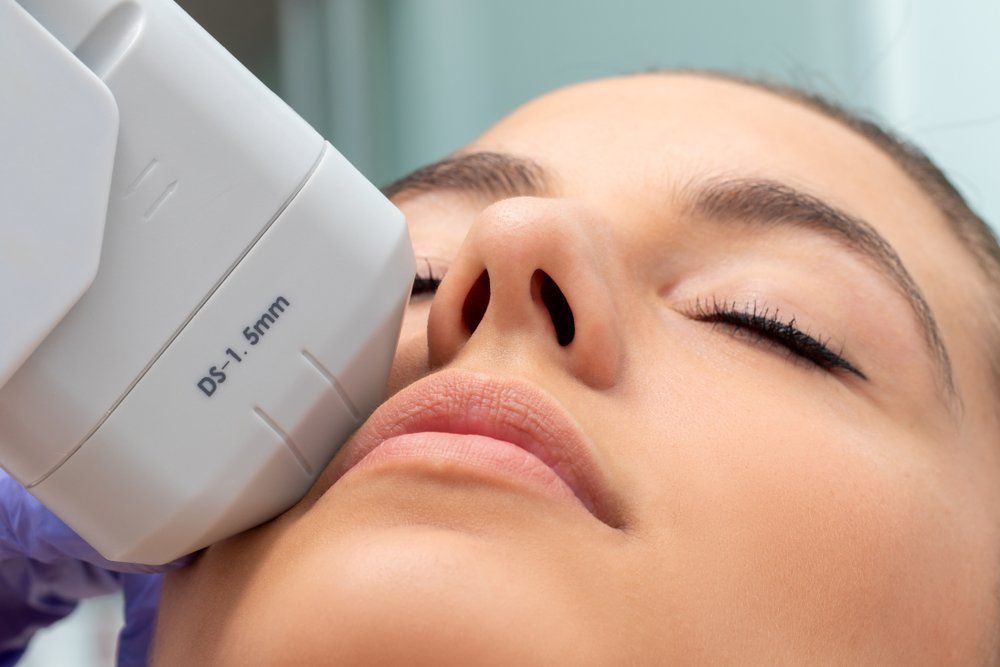 A Woman Is Getting an Ultrasound Treatment on Her Face — Skin Exquisite Laser & Cosmetic Clinic in Port Macquarie, NSW