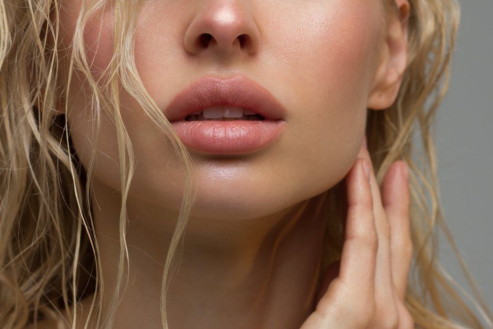 A Close up Of a Woman's Face with Her Hand on Her Chin — Skin Exquisite Laser & Cosmetic Clinic in Port Macquarie, NSW