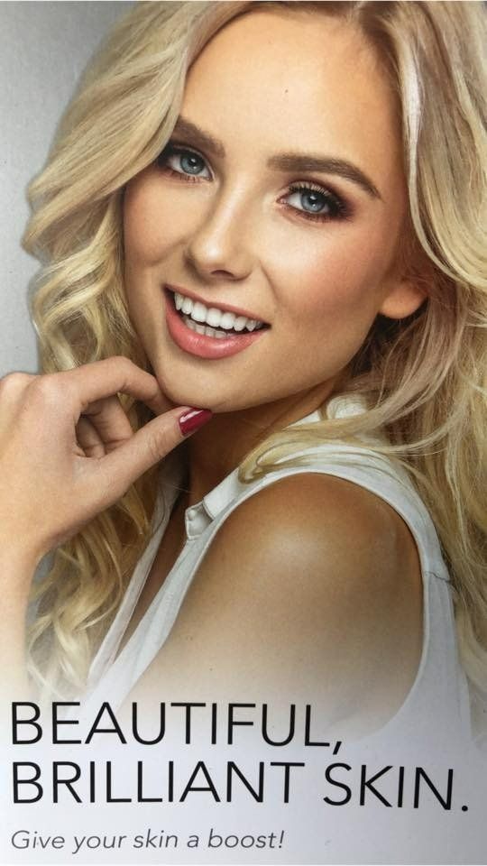 A Woman with Blonde Hair Is Smiling — Skin Exquisite Laser & Cosmetic Clinic in Port Macquarie, NSW