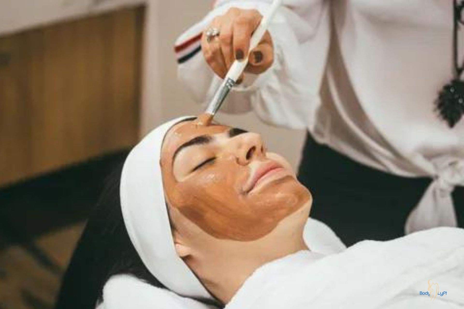 Esthetician performing facial treatment in Carmel spa