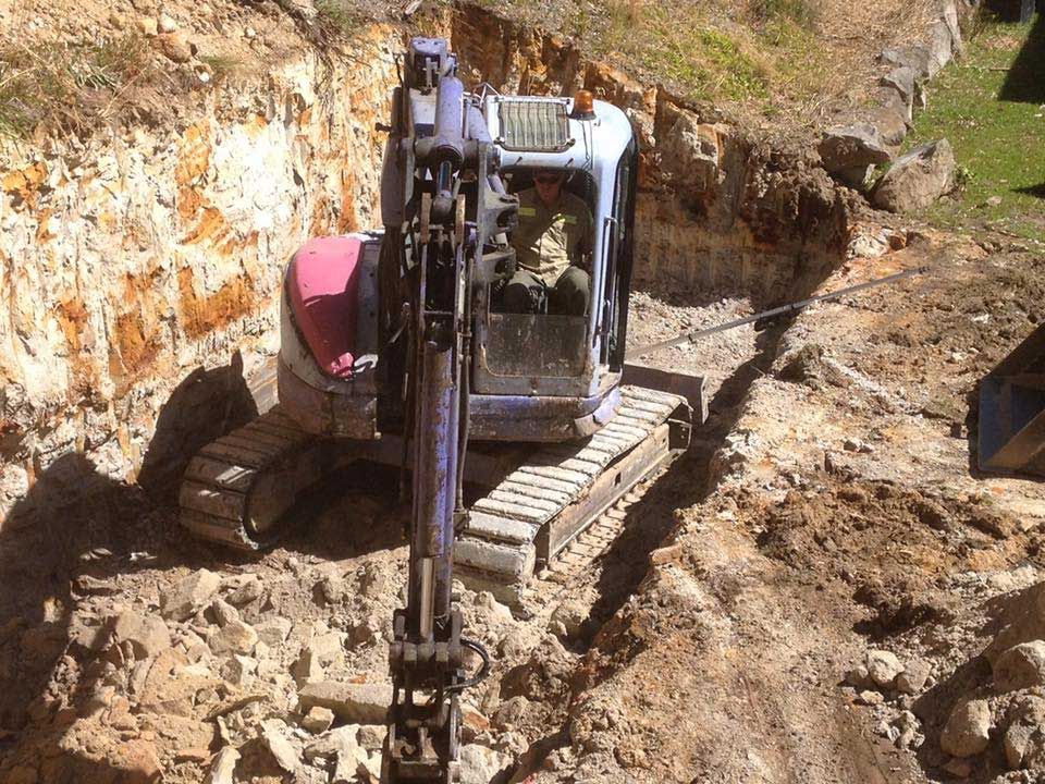 An Excavator Is Digging A Hole — Atholyn Earthmovers in Singleton, NSW