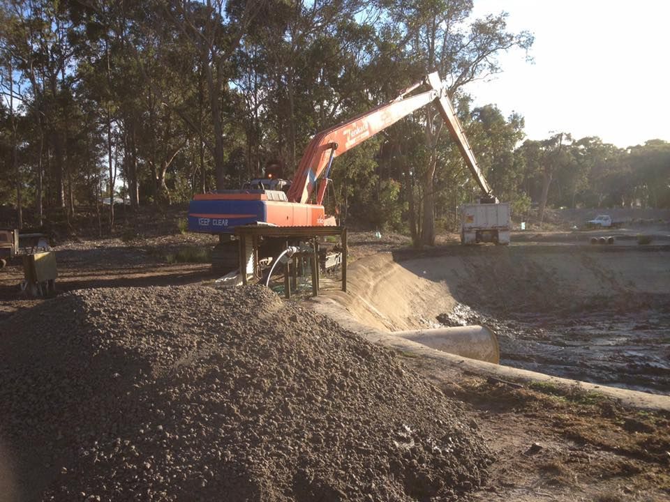 A Large Excavator Is Working On A Construction Site For Septic Tank — Atholyn Earthmovers in Branxton, NSW