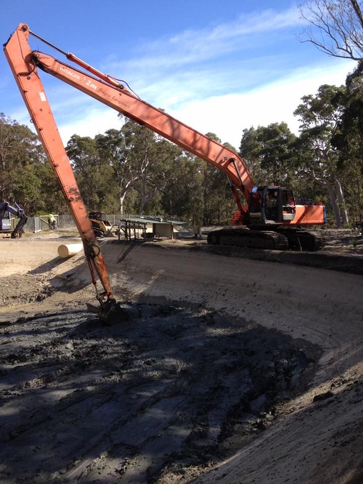A Large Orange Excavator With A Very Long Arm — Atholyn Earthmovers in Branxton, NSW