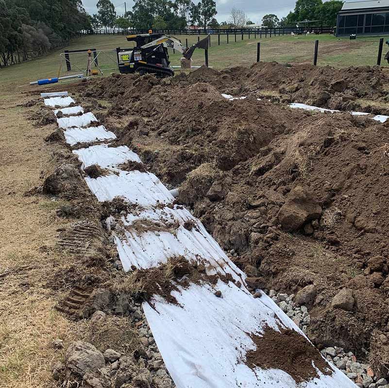 A Bulldozer Is Digging A Trench In The Dirt — Atholyn Earthmovers in Wyong, NSW