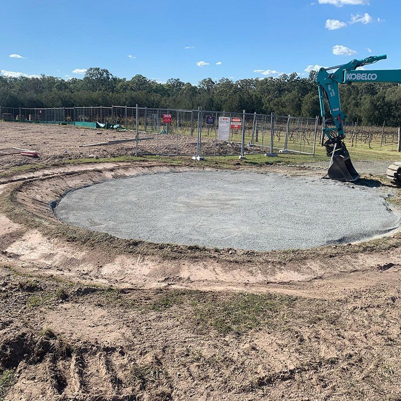 A Blue Kobelco Machine Is Excavating A Hole — Atholyn Earthmovers in Branxton, NSW