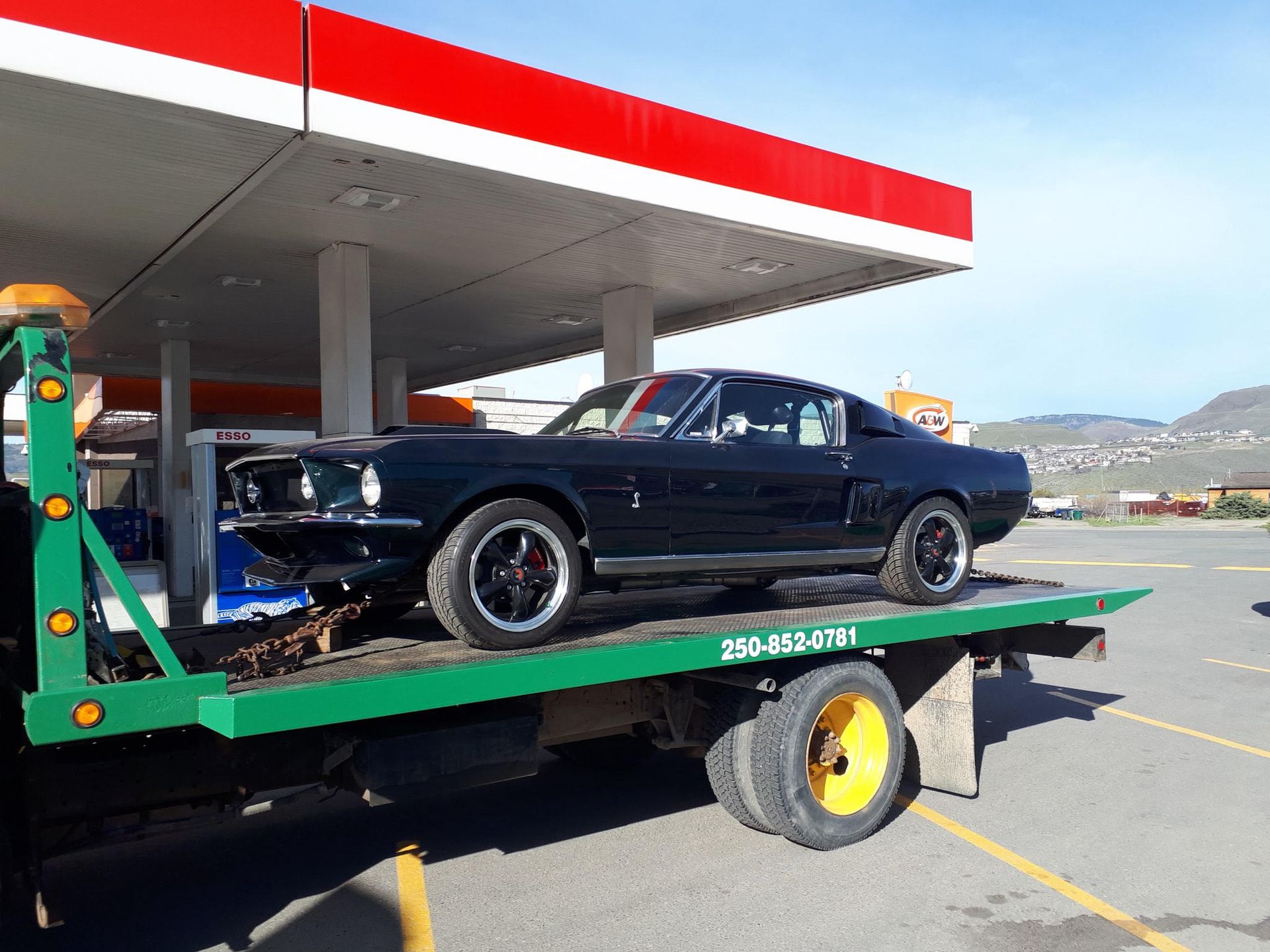 Muscle car being towed by Git-Er-Done Towing tow truck