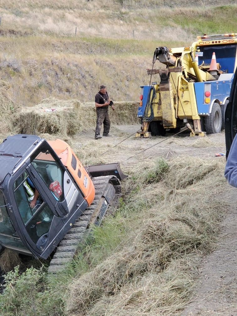 Winching out heavy equipment stuck in roadside ditch