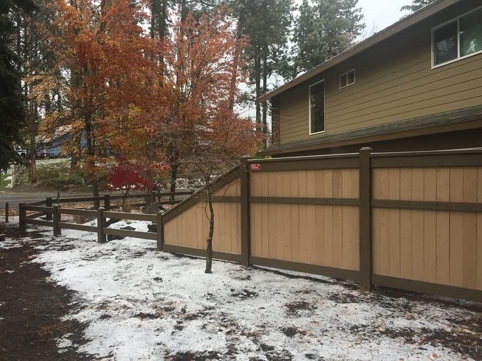 Black Wooden Fence with Tree and House — Hayden, ID — American Fence Company