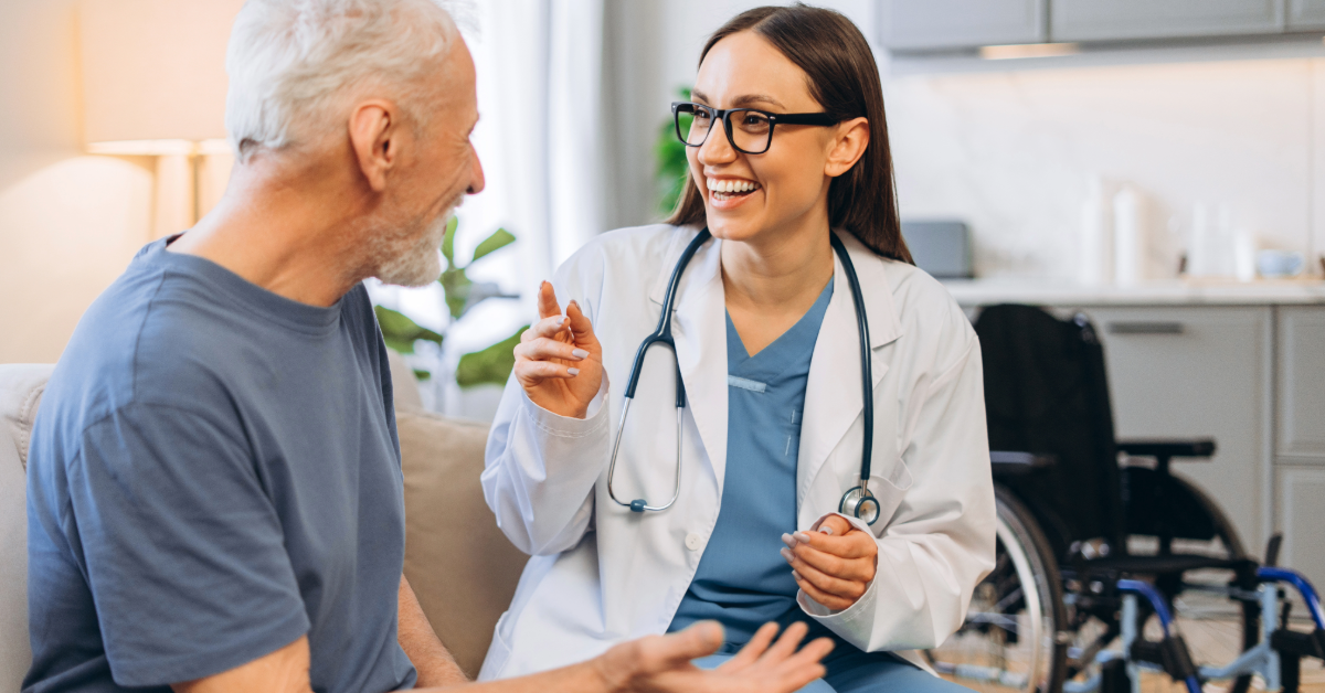 Nurse assisting an older person with medication in a well-lit room.