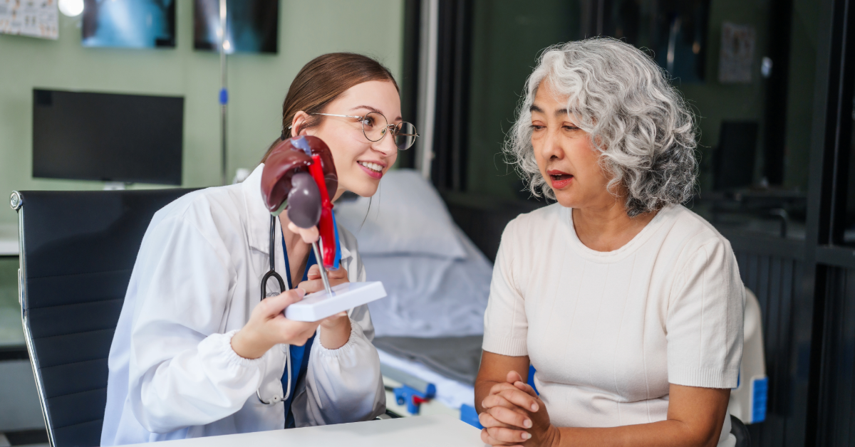 Nurse offers water to an elderly woman in a cozy home setting; both smiling.