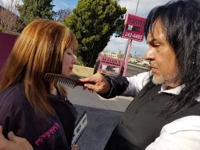 Women's Haircut — Stylist Straightening The Woman's Hair in Albuquerque, NM
